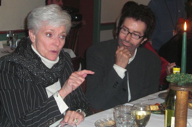George listens on as Lee talks to a dinner guest